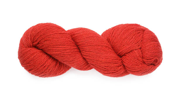 istock Red woolen yarn isolated on white, top view 1311602574
