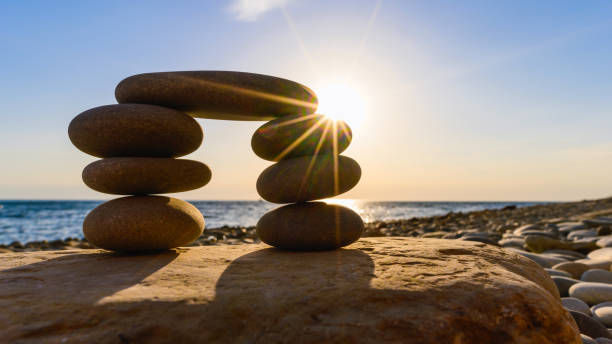 istock Sunrise over a small pebble tower on the beach. 1311602737