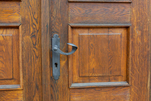 istock Rustic wooden door with a handle and keyhole. Copy space 1311605687