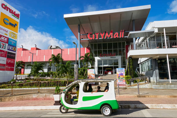 City Mall on Boracay Island on a sunny day An electronic tricycle with passengers waiting in front of the newly build City Mall building on Boracay Island, Philippines, Asia philippines tricycle stock pictures, royalty-free photos & images