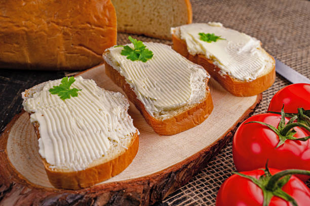 istock Tasty bread with butter on kitchen table 1311607518