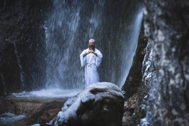 istock man in traditional japanese shugendo outfit doing waterfall meditation 1311609016
