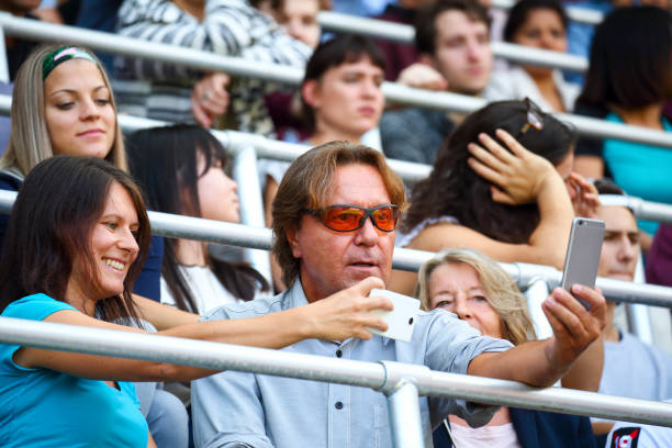 istock People taking a selfies at a footbal match 1311611498