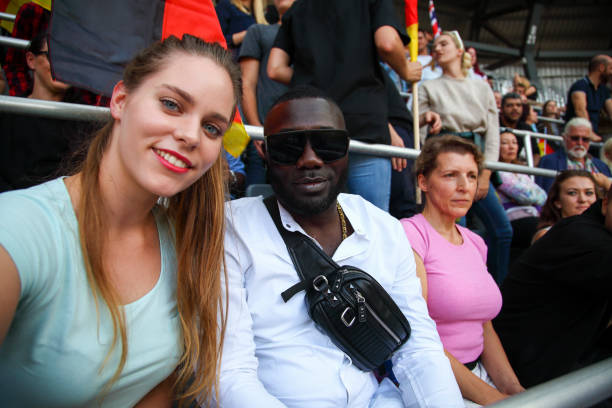 istock Interracial couple at footbal match making selfie 1311611538