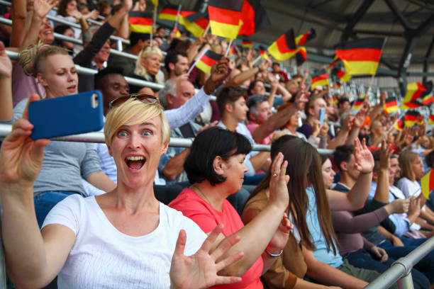 istock Female fan taking a selfie at a footbal match 1311611640