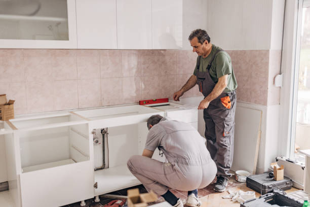 istock Two carpenters install a new white kitchen 1311612755