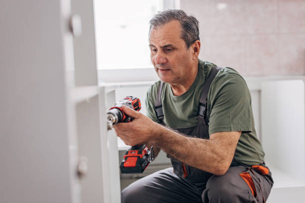 istock Active senior works, installs the furniture 1311612898