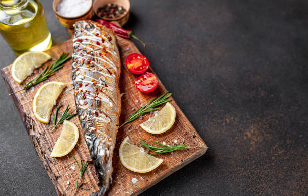 istock baked mackerel on a cutting board with lemon and spices on a stone background 1311613237