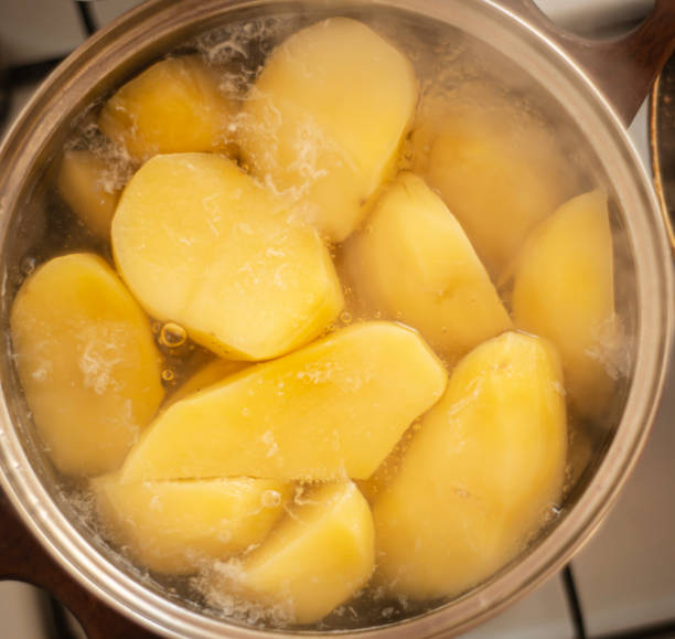 istock boiling potatoes in a saucepan, boiling potatoes on the stove, 1311613680