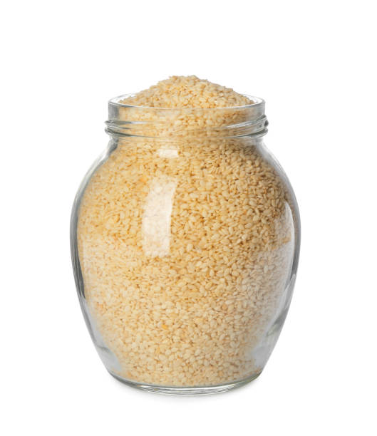 istock Glass jar with sesame seeds on white background 1311616351