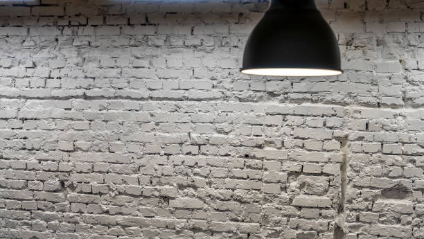istock A black lamp in the interior against a white brick wall. Space for text. Image for design. 1311619441