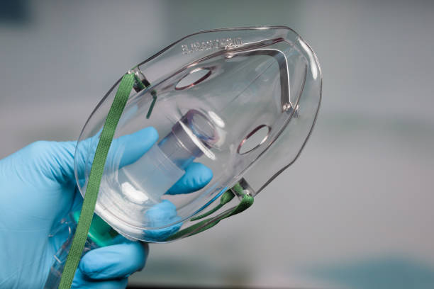 istock Doctor's hand with disposable oxygen mask for breathing support 1311619700