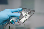 Doctor's hand with disposable oxygen mask for breathing support