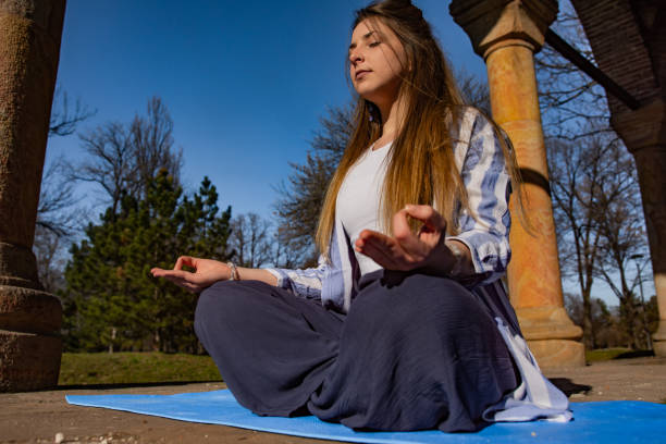 istock Beaitiful young woman practicing yoga in the park 1311622274