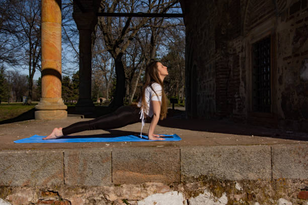 istock Beaitiful young woman practicing yoga in the park 1311622284