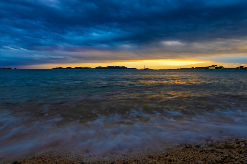 Heavy clouds and strong wind wiith waves in evening on the Adriatic coast in Istra during sunset, Croatia