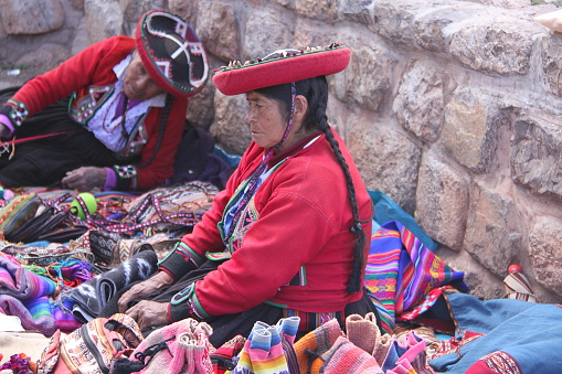 Two quechua women selling her artisan artifacts in the market at the andine village of Chinchero, Sacred Valley, Peru, 2017.