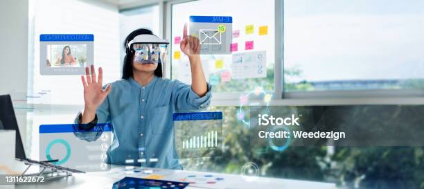 Asian Woman Using Augmented Reality And Mixed Reality Glasses Simulation Meeting And Working With Hologram Over Table At Officevirtual Reality Development Process Concept Stock Photo - Download Image Now