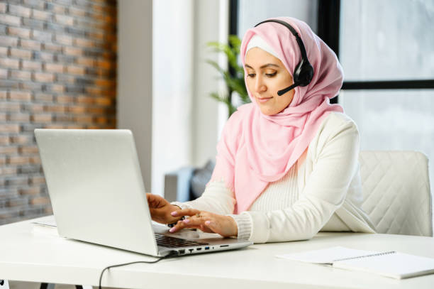 Free Stock Photo of Woman in hijab at the computer with headset ...