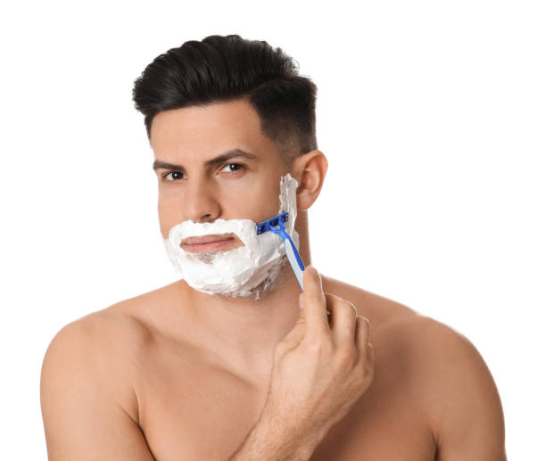 istock Handsome man shaving with razor on white background 1311624715