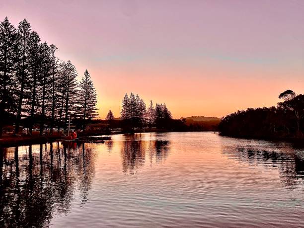 istock Pastel Sunset Hues Relfect on a Calm River 1311624800