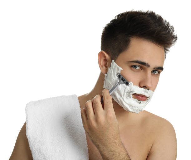 istock Handsome young man shaving with razor on white background 1311624876