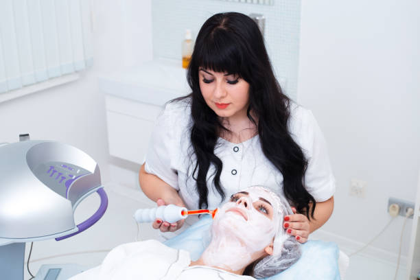 istock Receiving electric darsonval facial massage procedure. 1311626381
