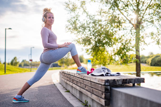 istock Young woman stretching before jogging 1311626423