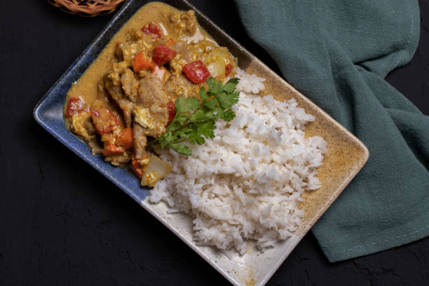 istock Stir fried pork curry powder in a square ceramic dish. 1311628979