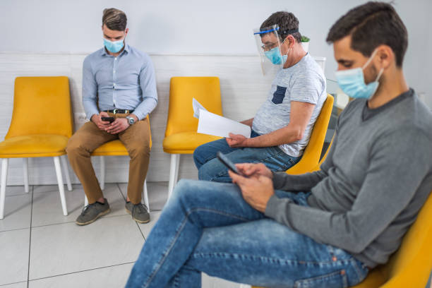 istock Patients with face masks in waiting room 1311629452