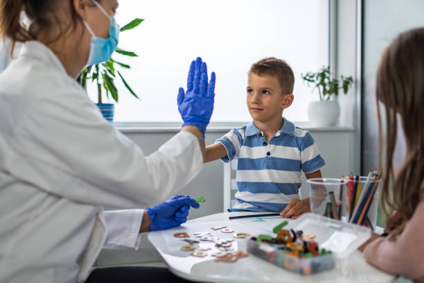 kinder im logopädenbüro - nurse high five mask stock-fotos und bilder
