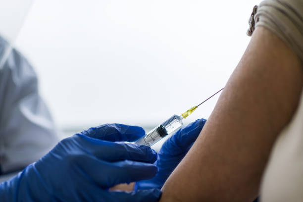 istock Mature woman taking a vaccine from her doctor 1311630708