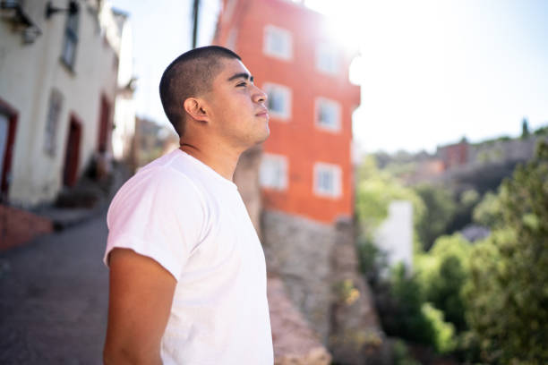 Young man looking away contemplating outdoors