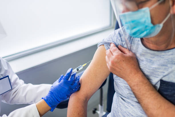 istock Mature man taking a vaccine from his doctor 1311632690
