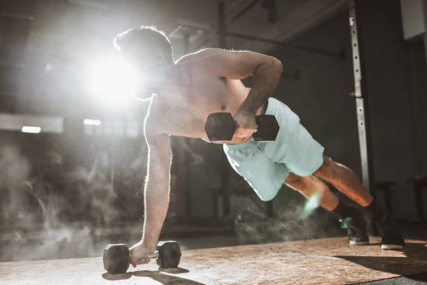 istock Handsome Male Athlete Working Out With Dumbbells In Gym 1311632846