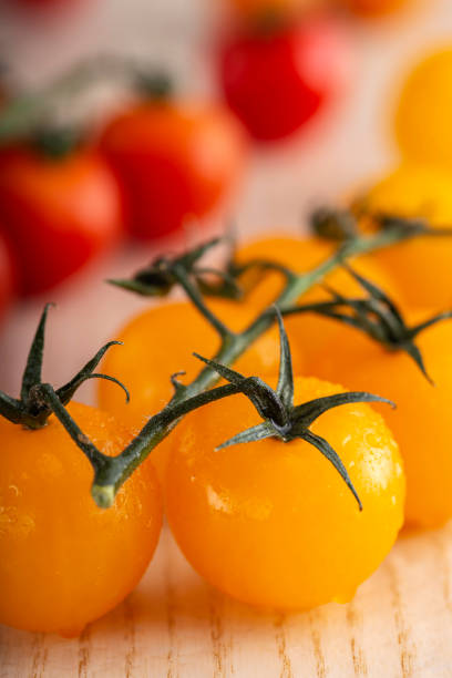 istock Yellow cherry tomatoes with water drops 1311632886