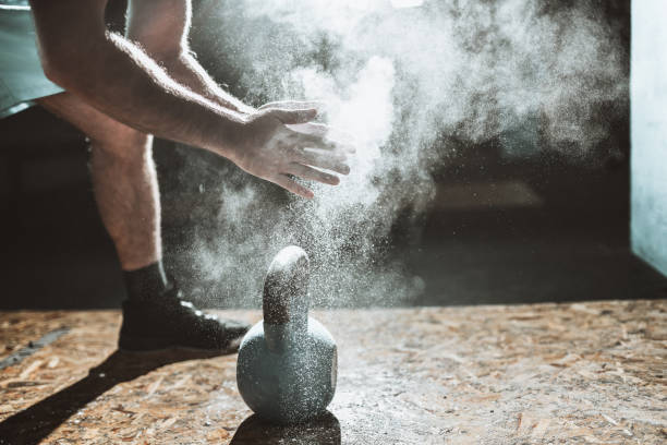 istock Athletic Male Ready To Do Kettlebell Training On Dusty Gym Ground 1311632997