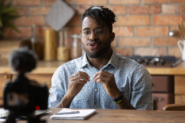 istock Successful afro american male video blogger record speech using webcam 1311634198