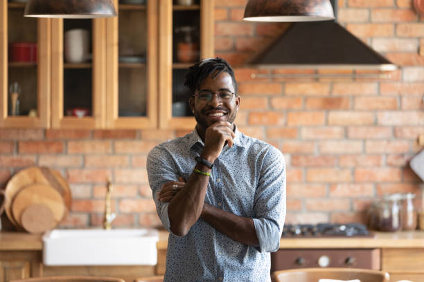istock Smiling african american man posing for portrait at kitchen interior 1311634230
