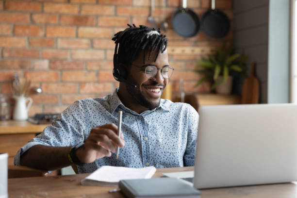 istock Laughing young african guy enjoy good joke on laptop screen 1311634239