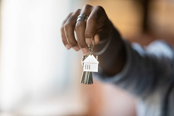 Closeup of young african male hand hold bunch of keys Welcome to new house. Close up of young african american man hand hold bunch of keys. Cropped shot of black guy real estate agent Real Estate Agent give offer you client key from home flat apartment. Copy space house key stock pictures, royalty-free photos & images