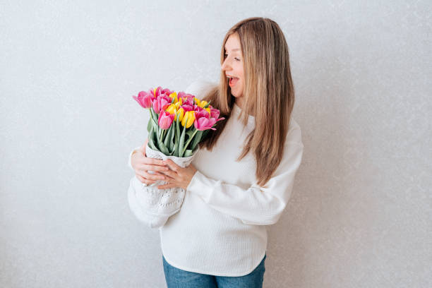 istock Emotional woman holding tulips 1311635231