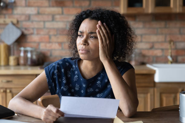 istock Young black lady hold paper letter think of solving problem 1311638365