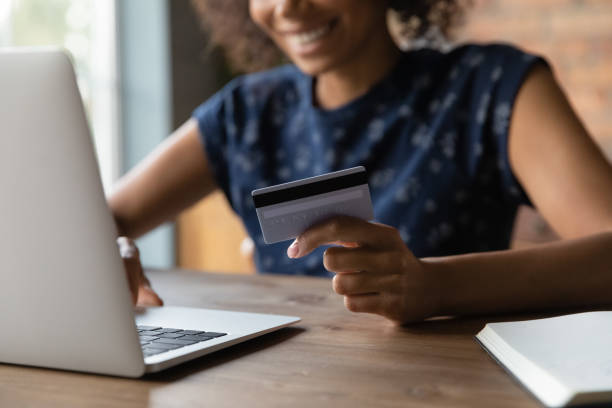 istock Satisfied black woman electronic bank client pay online using card 1311638371