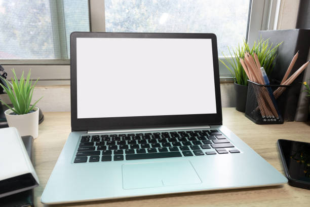 istock Laptop computer with white blank screen on desk in workspace and copy space concept 1311639613