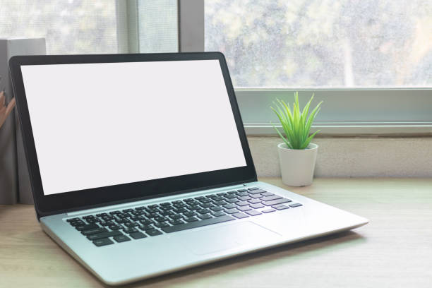 istock Laptop computer with white blank screen on desk in workspace and copy space concept 1311639710