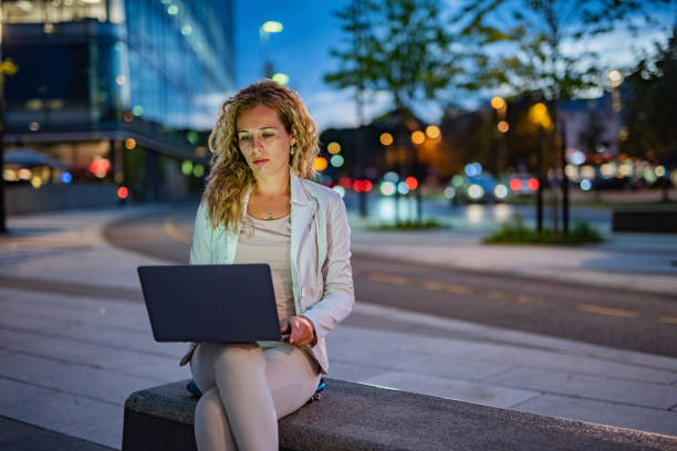 istock Woman sitting on the bench and using laptop 1311639733