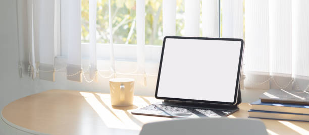 istock Laptop computer with white blank screen on desk in workspace and copy space concept 1311641287