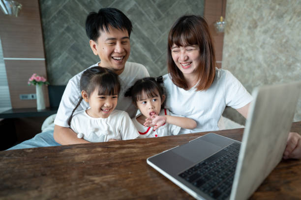 istock Social teleconferencing, Asian daughters and single mothers take online classes Via a computer with a wireless internet system. 1311642223