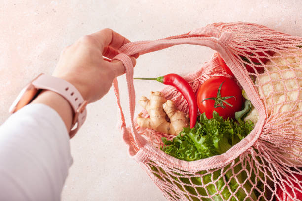istock hand holding fruits vegetables in reusable mesh cotton bag, plastic free zero waste concept 1311642327
